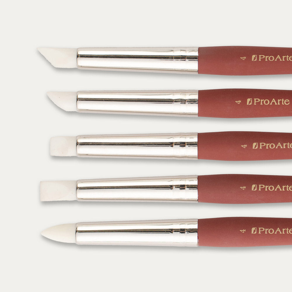 Closeup of the tips of five Pro Arte Colour Applicators arranged in size order, laid out sideways on a white background.
