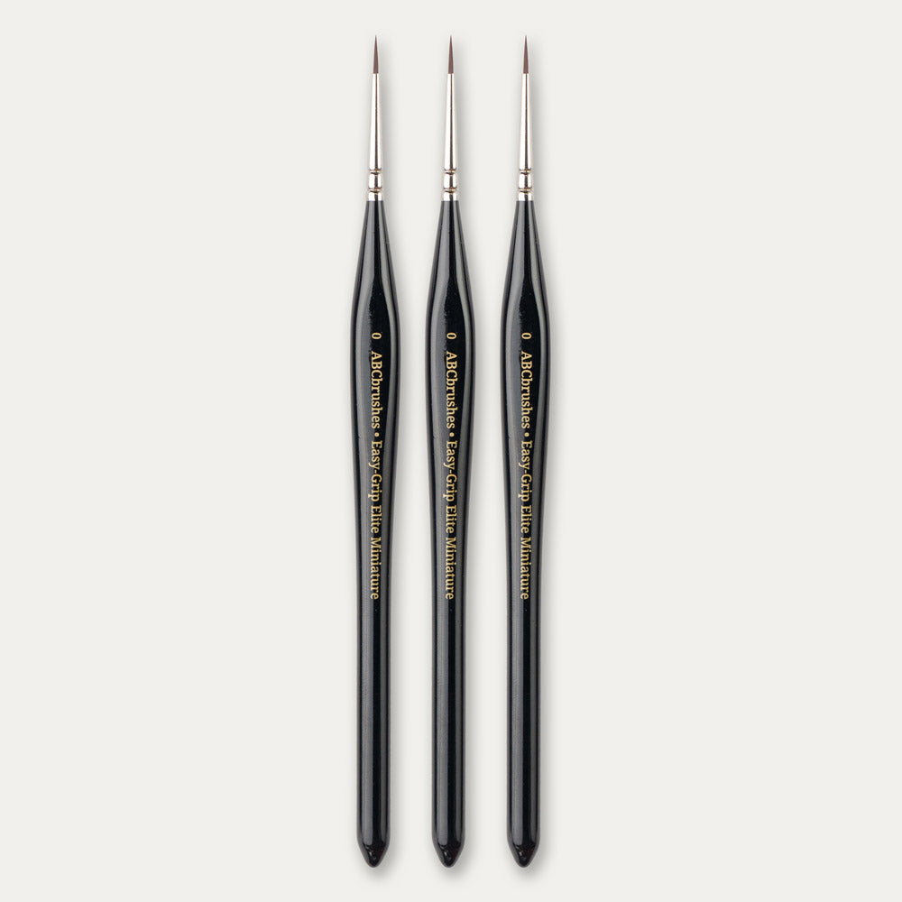 Three size 0 ABC Brushes Easy-Grip Elite Miniature Brushes on a white background.