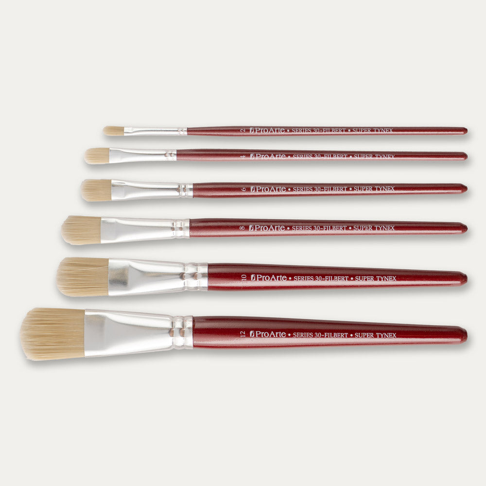 Six Pro Arte Filbert stippler brushes arranged in size order, laid out sideways on a white background.