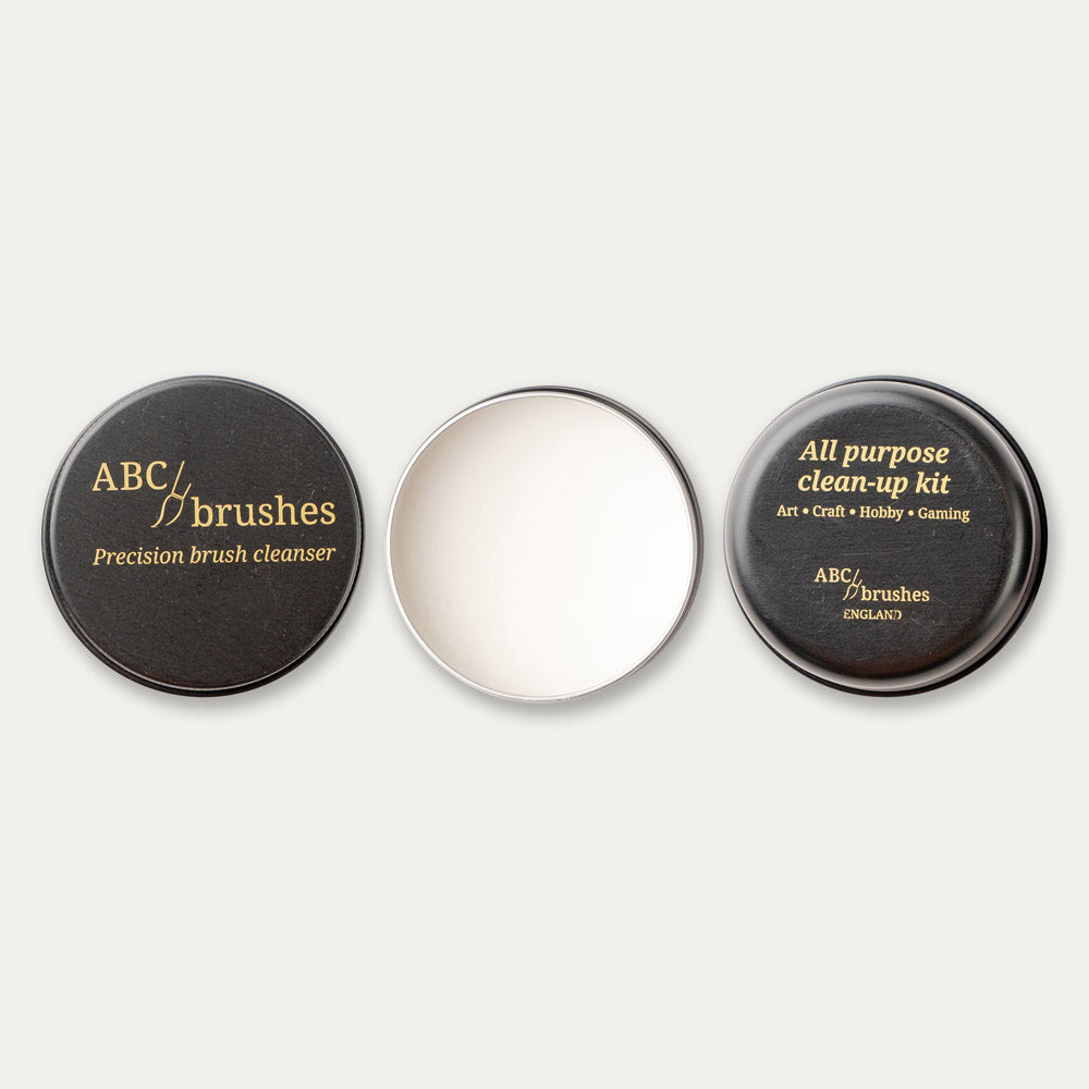 ABCbrushes lid, open product and bottom arranged in a line on a white background.