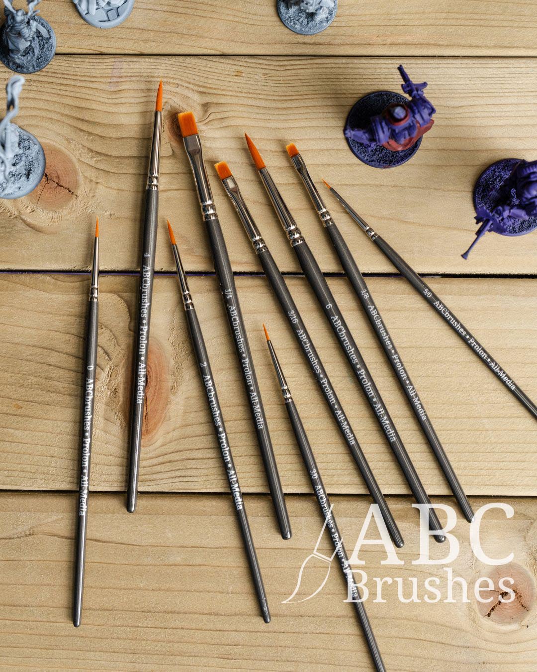 ABC Brushes All media Prolon brush range on a wooden background and next to some incomplete minis. 