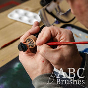 Painting the yes on a cowboy mini figure head with an ABC Brushes Tri-Grip Detailer paint brush.