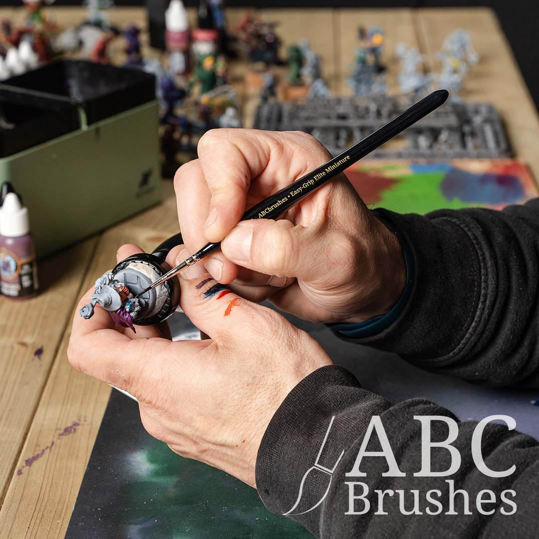 Painting a base coat on a wizard mini with an Painting a monkey astronaut mini figure with an ABC Brushes Easy-Grip Elite Miniature Brush. 