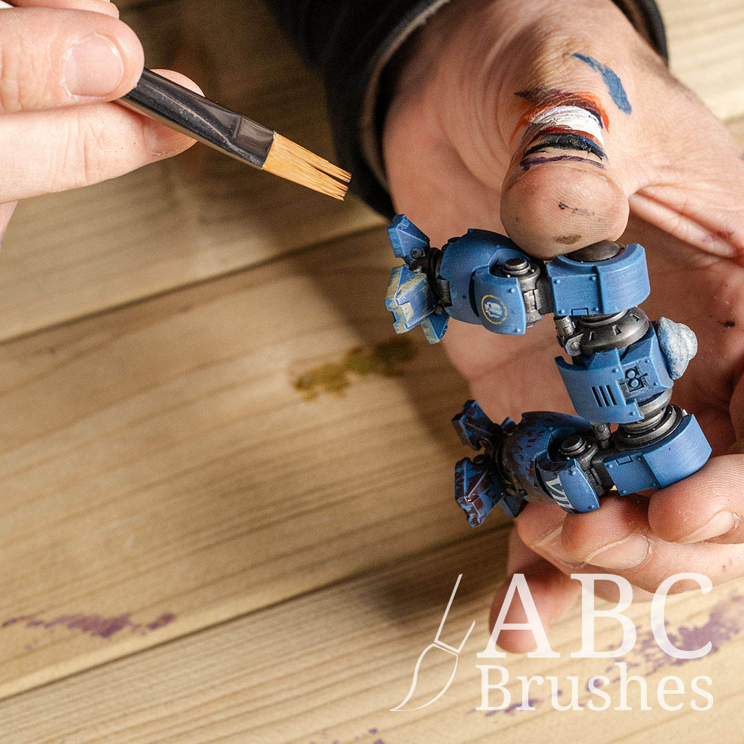 Painting a blue robot mini figure with a  Pro Arte Comb Paint Brush.