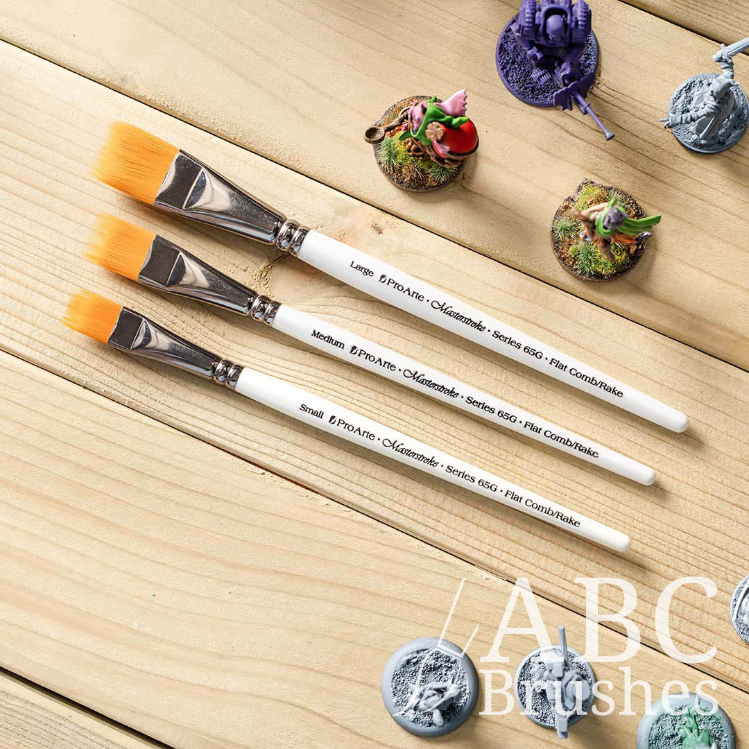 Pro Arte Comb Paint Brush set on a wooden background next to some painted and unpainted mini figures.