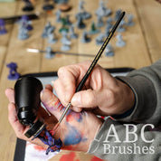 Painting a miniature figures basecoat with a Pro Arte Imperium paint brush.