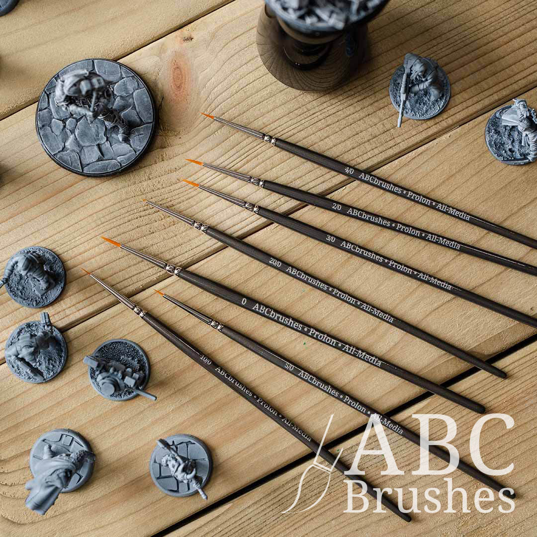 ABC Brushes Prolon All Media small brush range on a wooden background with various minis surrounding them. 