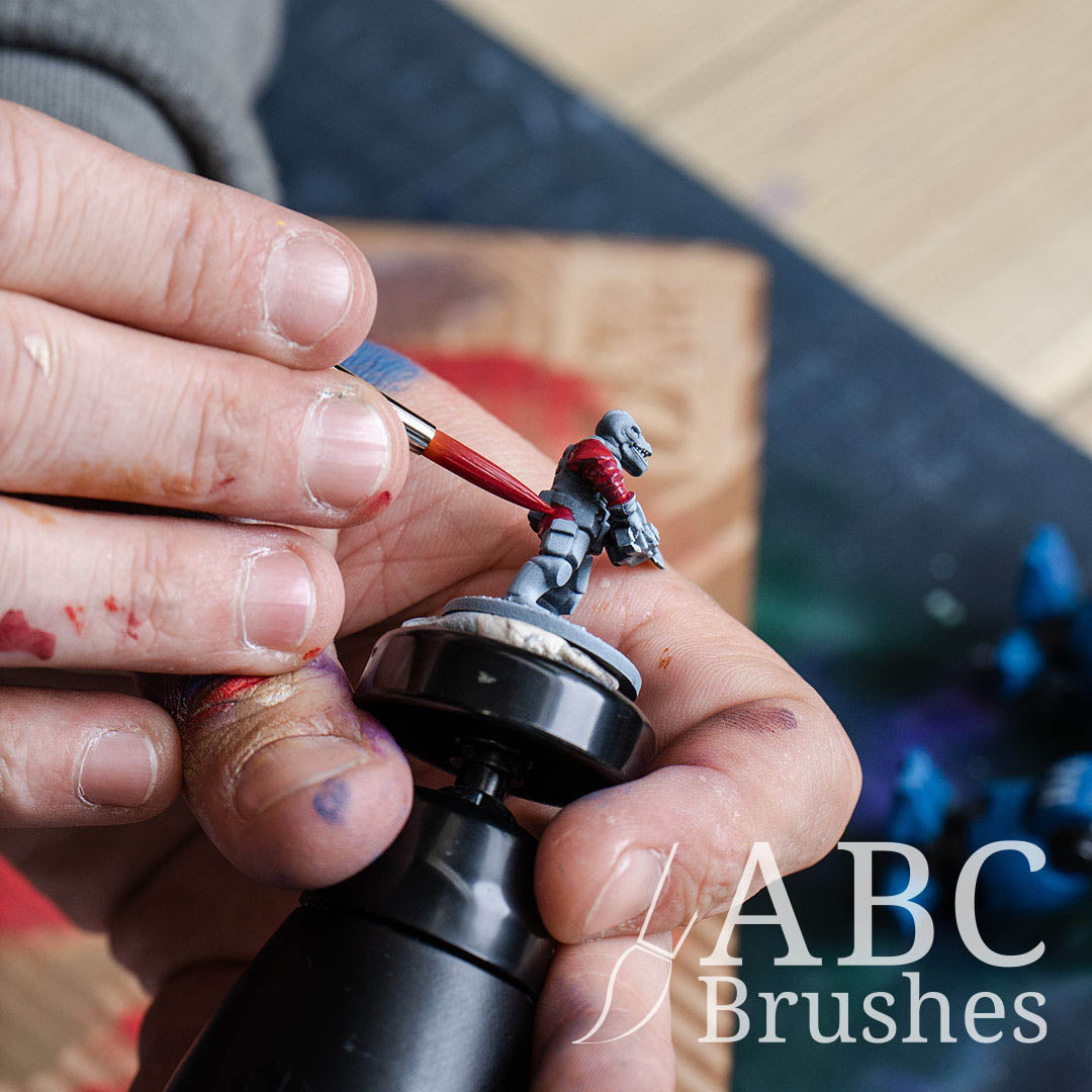 Close-up of painting the base coat of a mini figure with an ABC Brushes Prolon All Media brush.