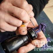 Painting a purple mini on a painting handle with a Pro Arte Rigger brush.