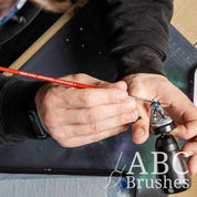 Painting blue detailing onto a mini with a ABC Brushes Spearhead paint brush.