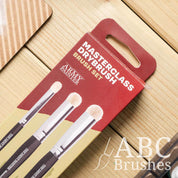 Closeup of the Army Painter Masterclass Drybrush set packaging on a wooden background. 