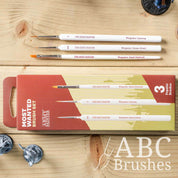 The Army Painter Most Wanted brush set next to the packaging on a wooden background.