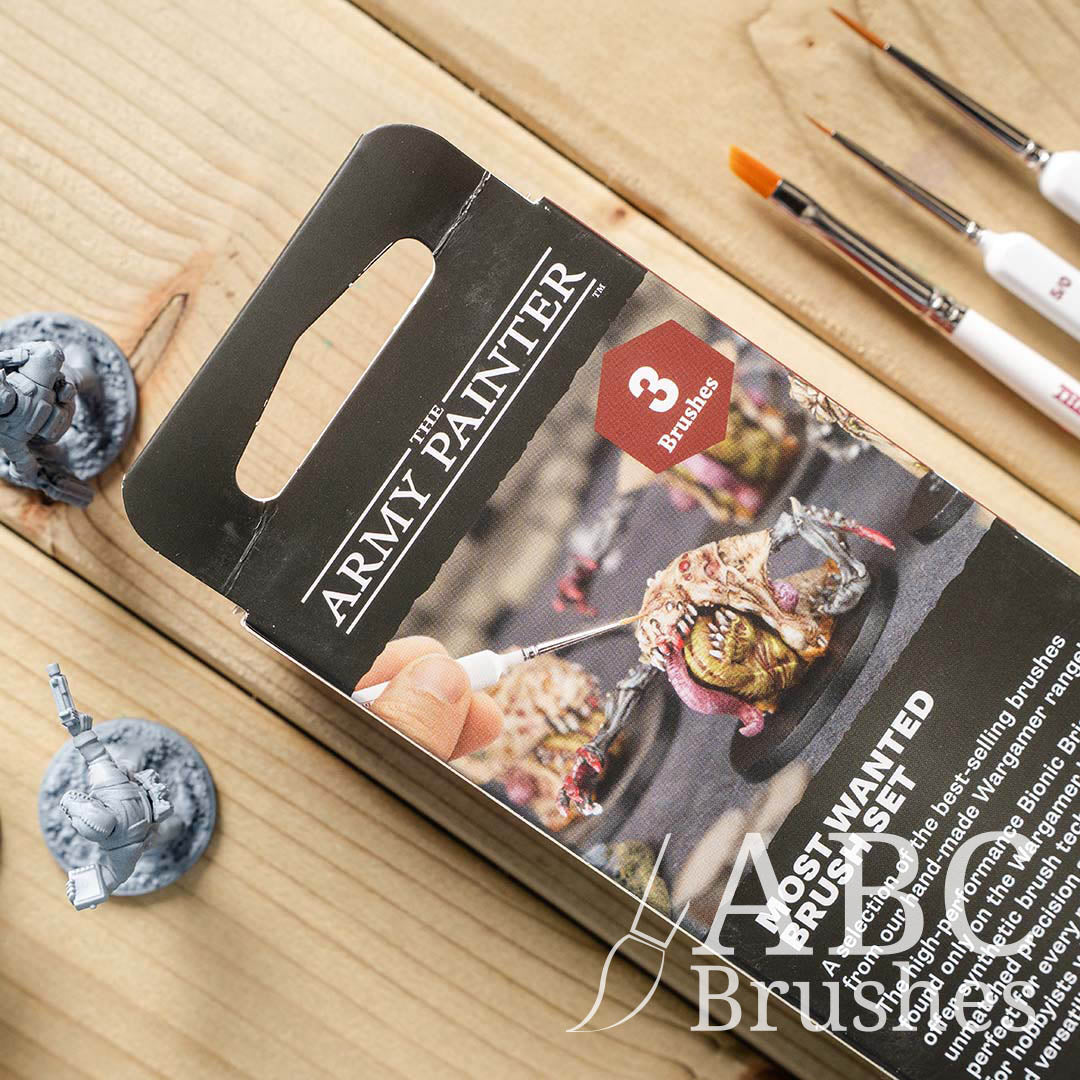 Packaging for the Army Painters Most Wanted brush set on a wooden background. 