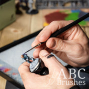 Painting a monkey astronaut mini figure with an ABC Brushes Easy-Grip Elite Miniature Brush.