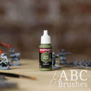 Bottle of the Army Painter Fanatics in the colour Army Green on a white background. There are splatters of paint emerging from the bottom of the paint bottle. 
