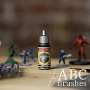 Bottle of the Army Painters Metallic Speedpaint in the colour Broadsword Silver, with wargaming models and an ABC paintbrush in the background, on a wooden surface.