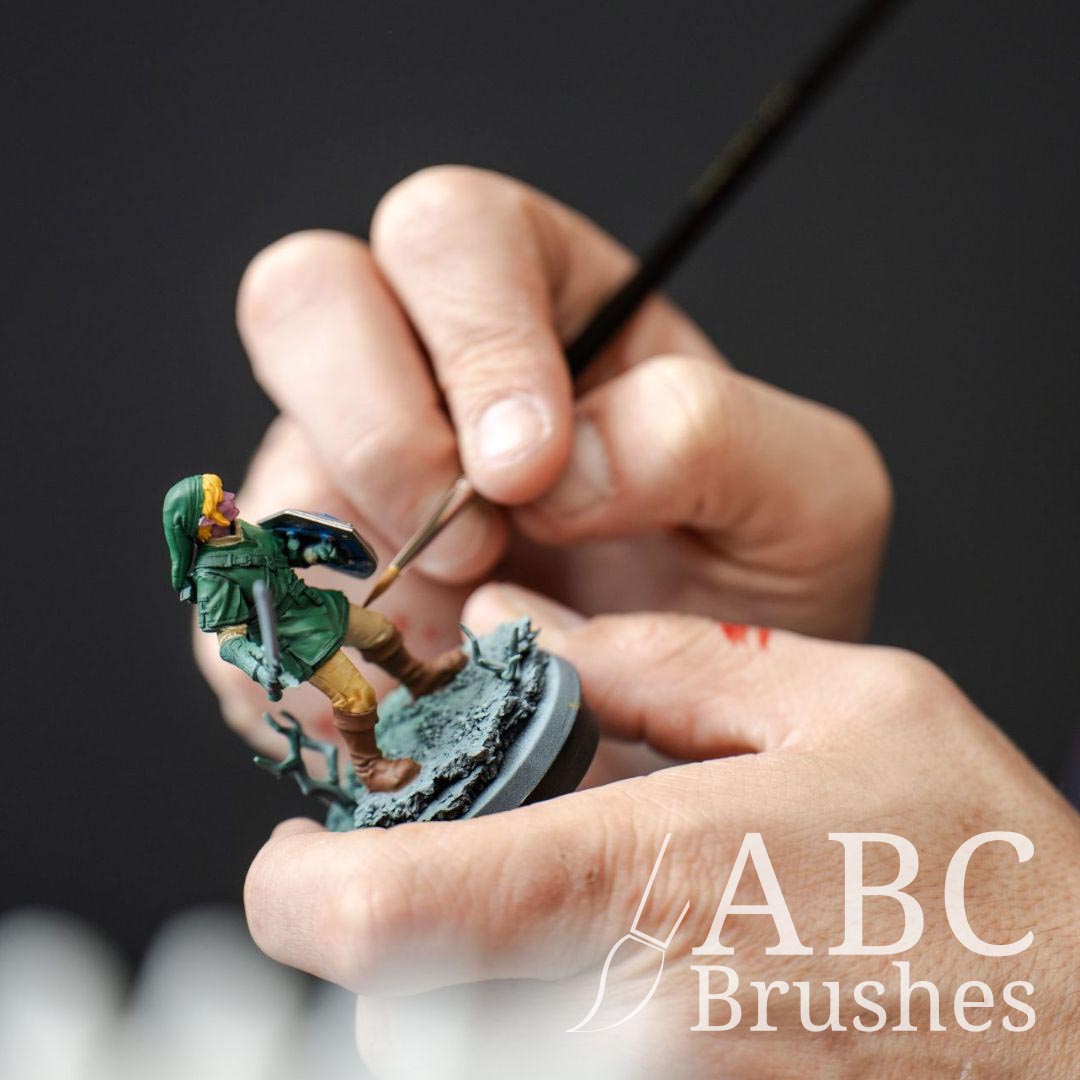 Painting detailing onto a Zelda miniature with an ABC Round brush.