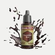 Bottle of the Army Painters Speedpaint in the colour Burnished Red on a white background. There are splatters of Burnished Red paint emerging from the bottom of the paint bottle. 