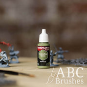 Bottle of the Army Painter Fanatics in the colour Camouflage Green on a white background. There are splatters of paint emerging from the bottom of the paint bottle. 