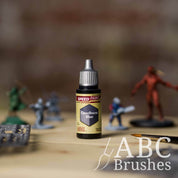 Bottle of the Army Painters Speedpaint in the colour Cloudburst Blue, with wargaming models and an ABC paintbrush in the background, on a wooden surface.