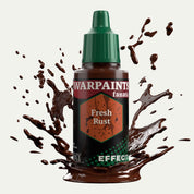 Bottle of the Army Painter Fanatics Effects in the colour Fresh Rust on a white background. There are splatters of paint emerging from the bottom of the paint bottle. 