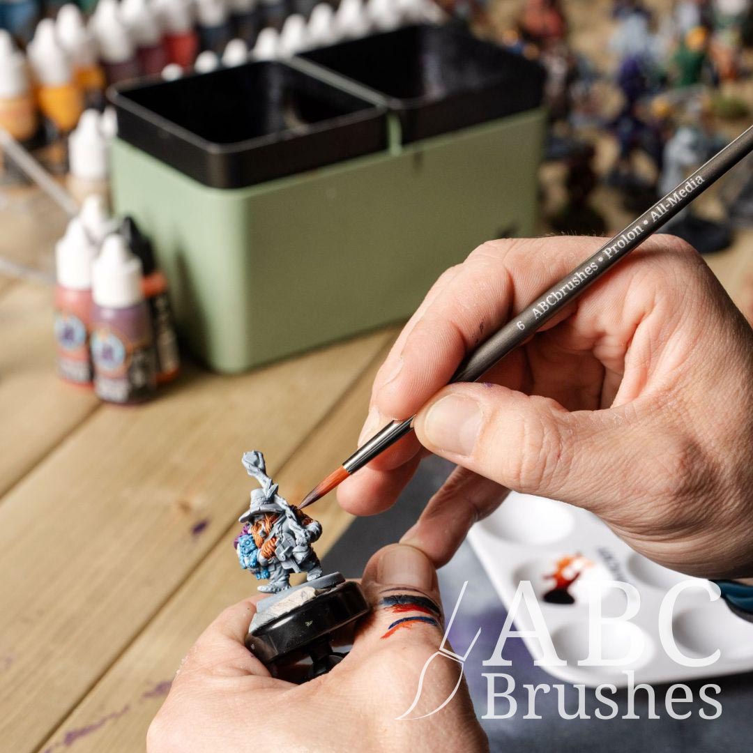 Painting a basecoat onto a mini figure with an ABC Brushes Easy Grip brush.