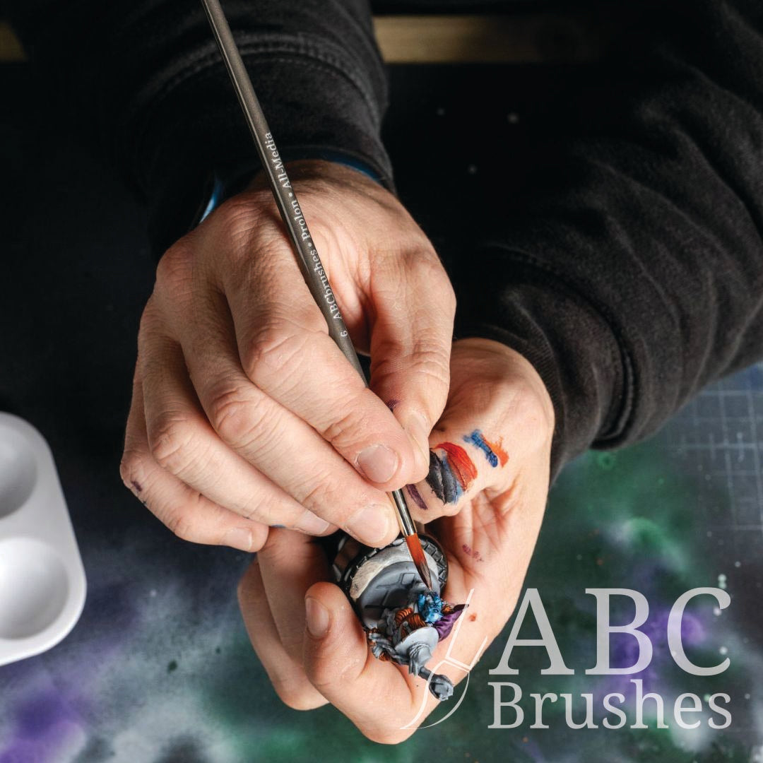 Painting a basecoat onto a mini figure with an ABC Brushes Prolon brush.