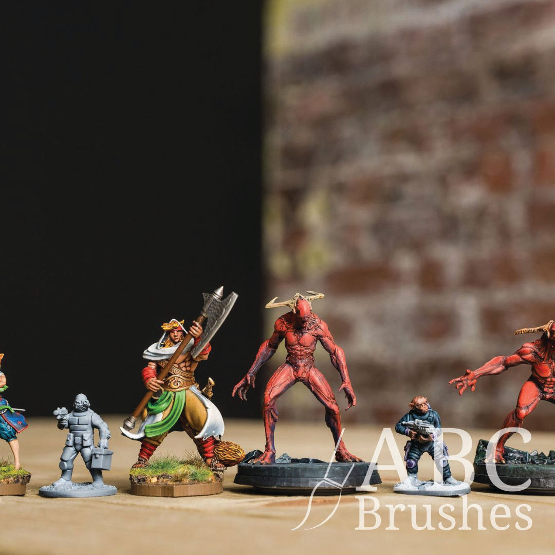 Collection of mini wargaming figures on a wooden surface with a blurred background.