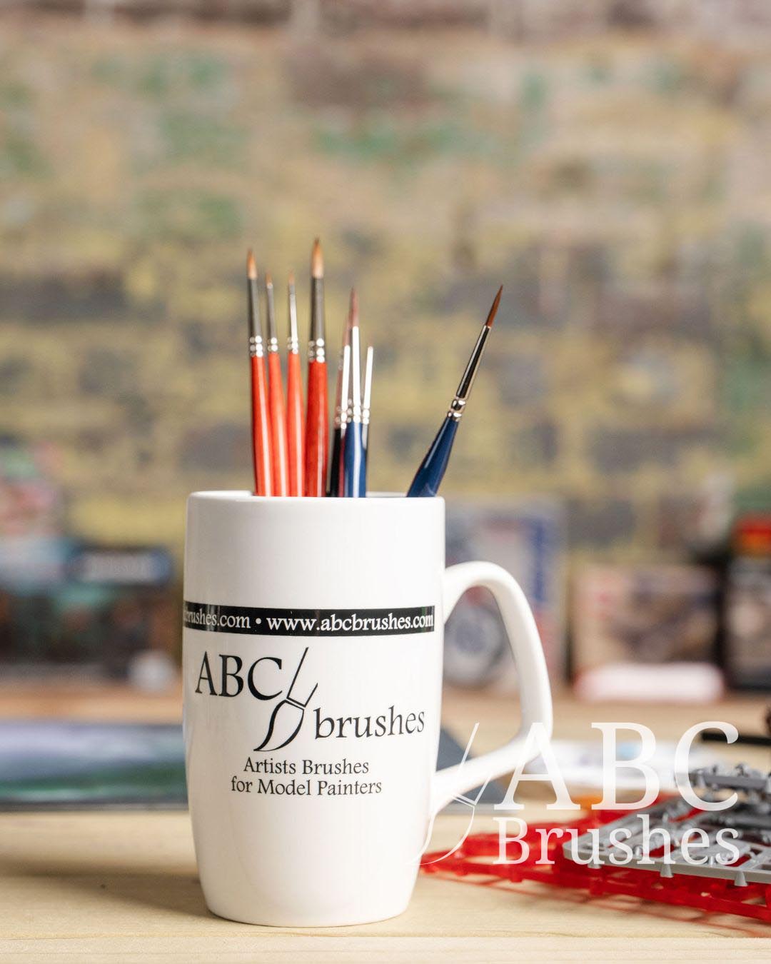 Various different ABC brushes placed bristles up in an ABC brushes mug. 